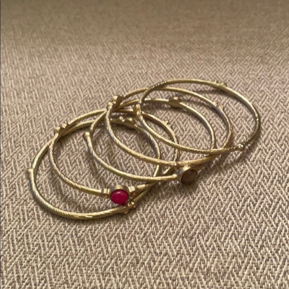 Set of 5 gold bracelets with pink and gold stones
